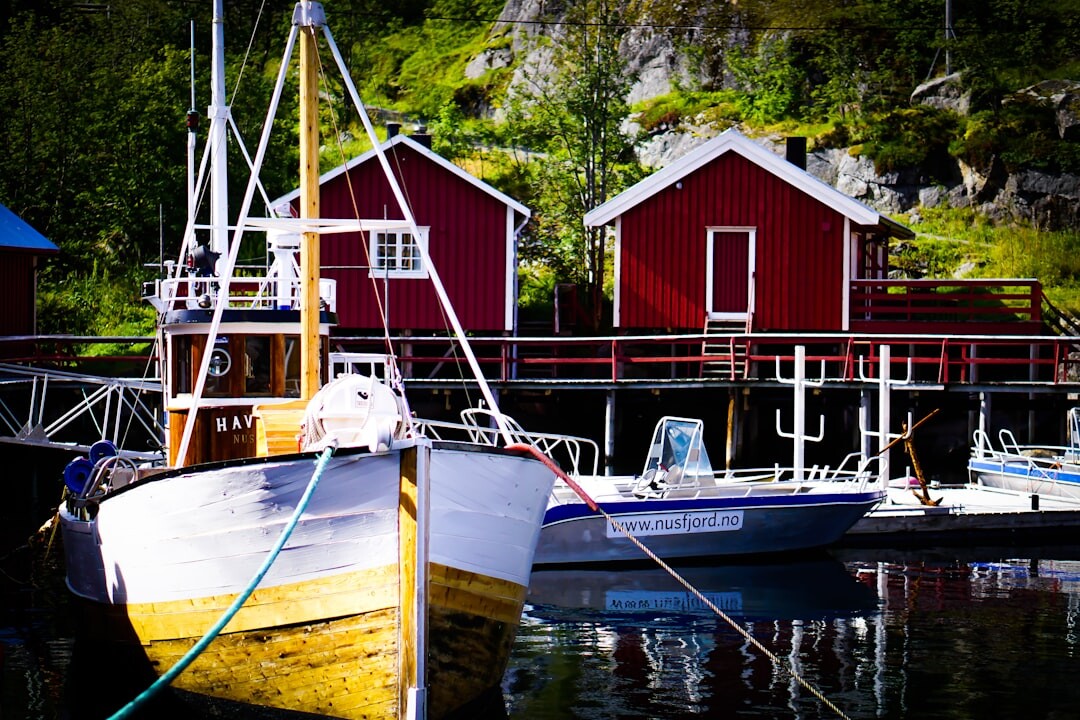Scandinavian fishing village harbour with wooden boats and colourful houses