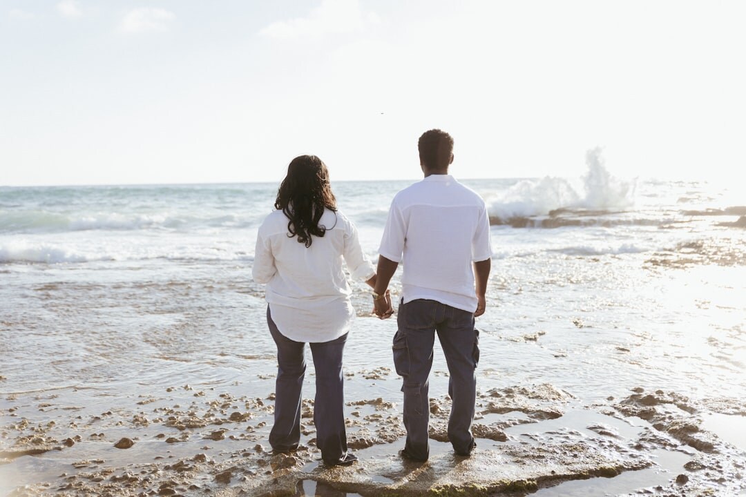 couple holding hands on beach