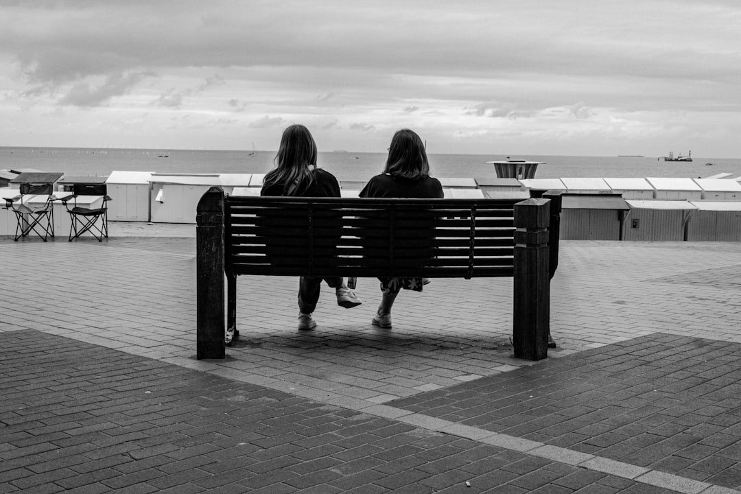 woman sharing story on bench